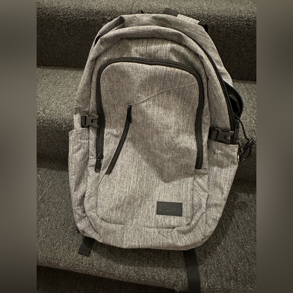 Gray Backpack with Leather Accents and Modern Design